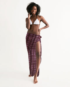 Model with purple spotted scarf intricately wrapped around waist as a long ankle length skirt.