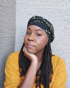 Model with head in hand with Olive Green Dotted Scarf Wrapped around her head.